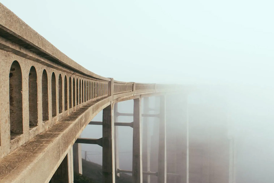 bridge disappears into fog