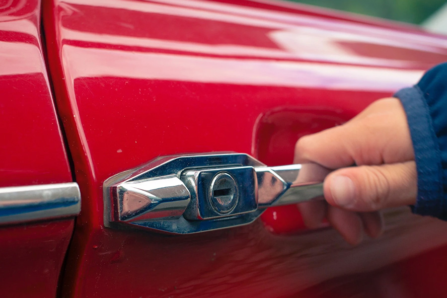 man opening red car