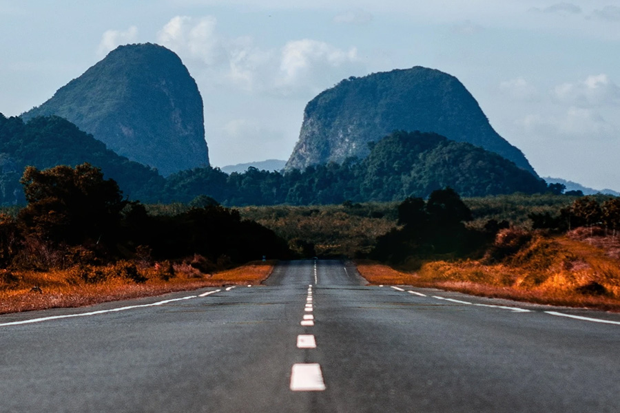 road with buttes in distance