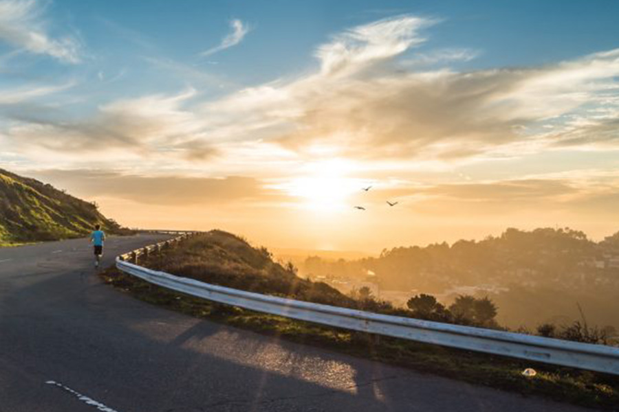 woman running on windy road