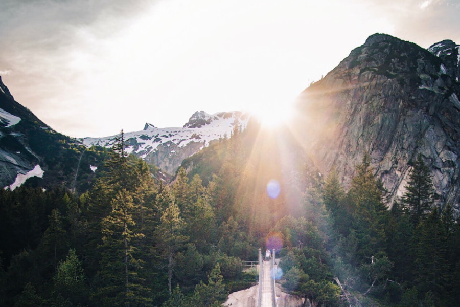 mountains with glare from sun over peak