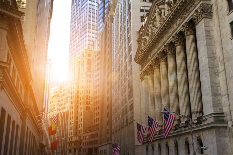 wall street buildings with rising sun