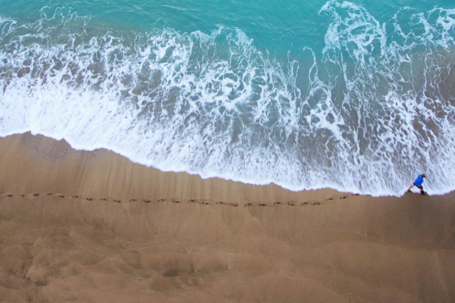 shoreline with footprints in sand