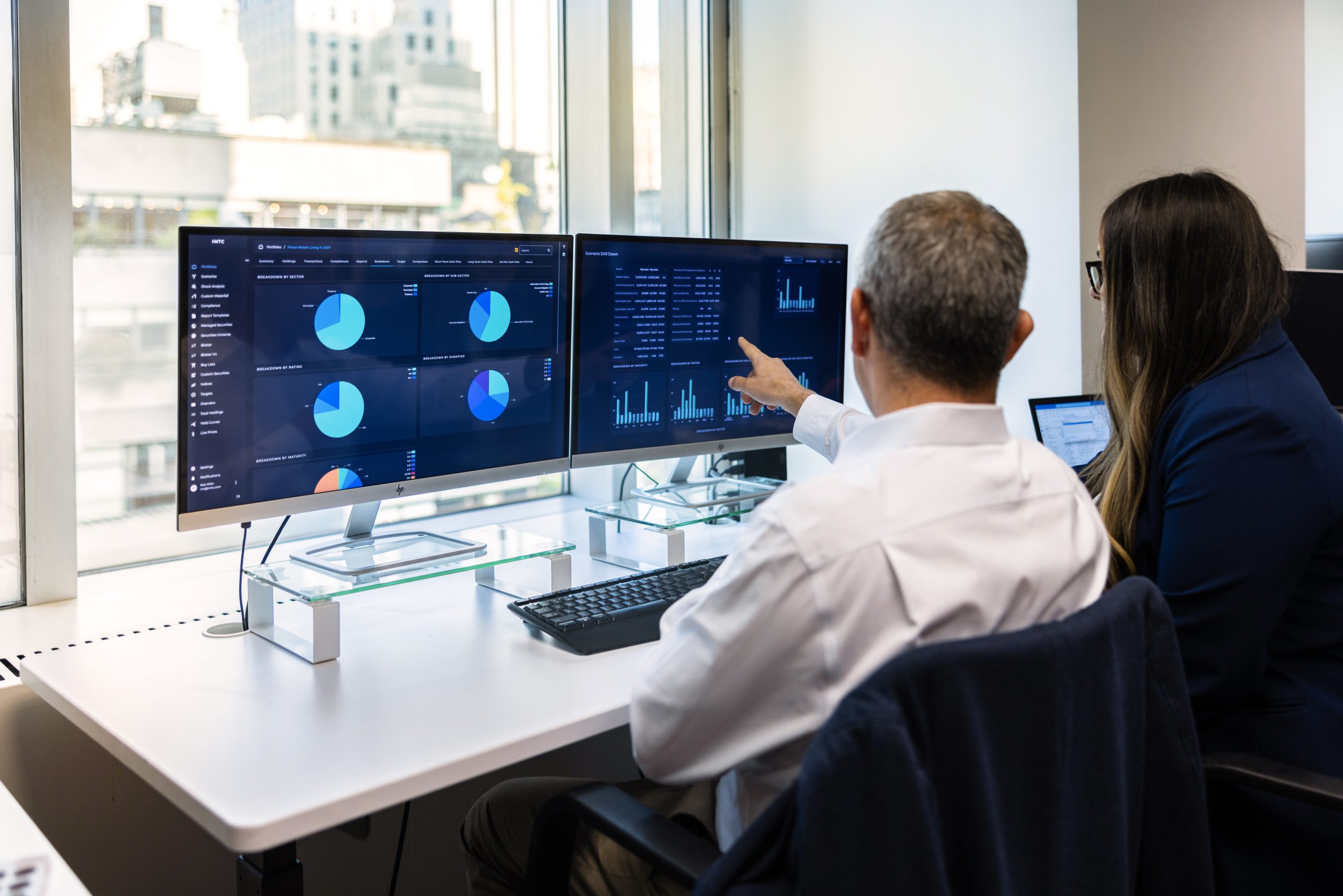 two people working at monitors